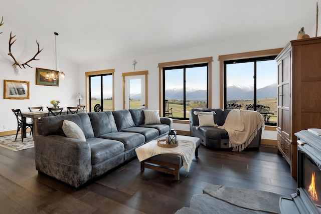 559 Stage Springs Ln, Stevensville, MT 59870 - living area featuring dark wood-style flooring, a chandelier, lofted ceiling, and a mountain view