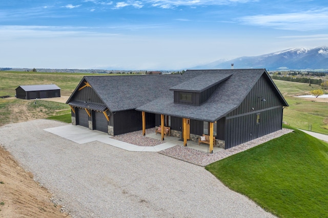 559 Stage Springs Ln, Stevensville, MT 59870 - modern farmhouse with a porch, stone siding, gravel driveway, and a mountain view