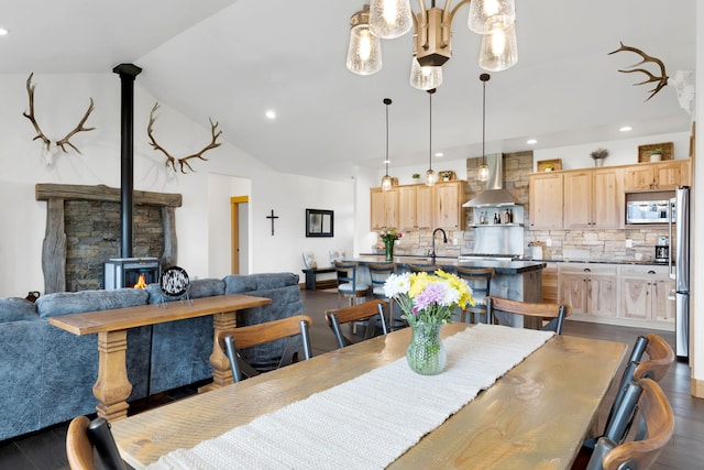 559 Stage Springs Ln, Stevensville, MT 59870 - dining area with dark wood finished floors, a wood stove, recessed lighting, and vaulted ceiling