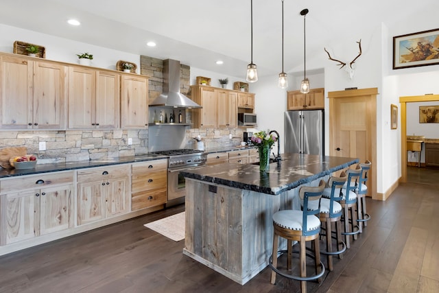 559 Stage Springs Ln, Stevensville, MT 59870 - kitchen with stainless steel appliances, wall chimney exhaust hood, a sink, light brown cabinets, and backsplash