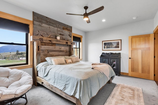 559 Stage Springs Ln, Stevensville, MT 59870 - bedroom featuring light colored carpet, multiple windows, and a ceiling fan