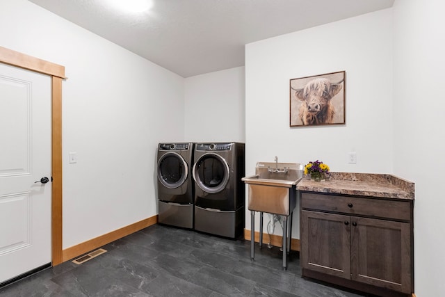559 Stage Springs Ln, Stevensville, MT 59870 - clothes washing area with washer and clothes dryer, baseboards, and cabinet space