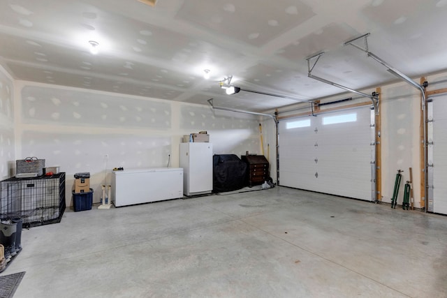559 Stage Springs Ln, Stevensville, MT 59870 - garage featuring fridge, a garage door opener, and freestanding refrigerator