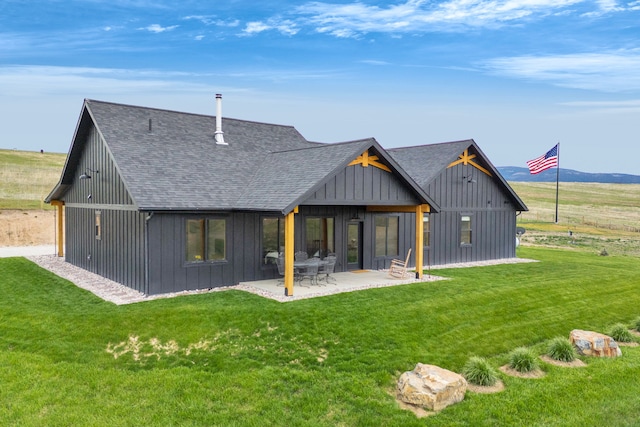 559 Stage Springs Ln, Stevensville, MT 59870 - back of house with roof with shingles, a lawn, and a patio area