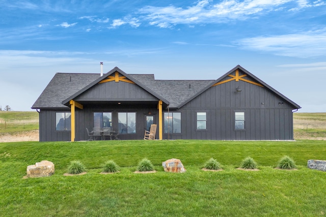 559 Stage Springs Ln, Stevensville, MT 59870 - back of property featuring a lawn, a shingled roof, and board and batten siding
