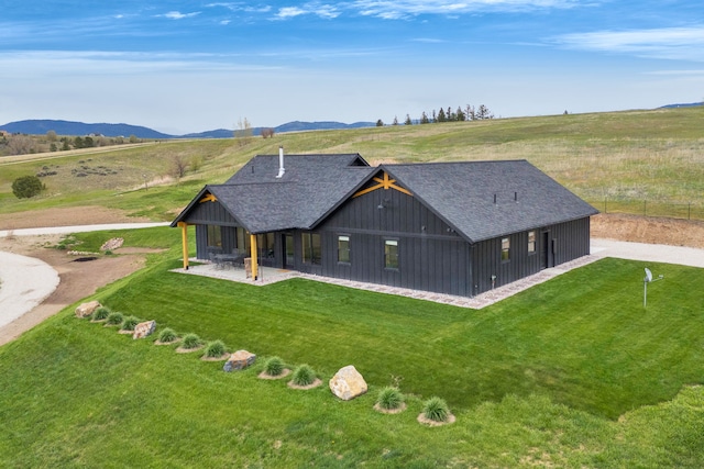 559 Stage Springs Ln, Stevensville, MT 59870 - rear view of property with a lawn and a mountain view