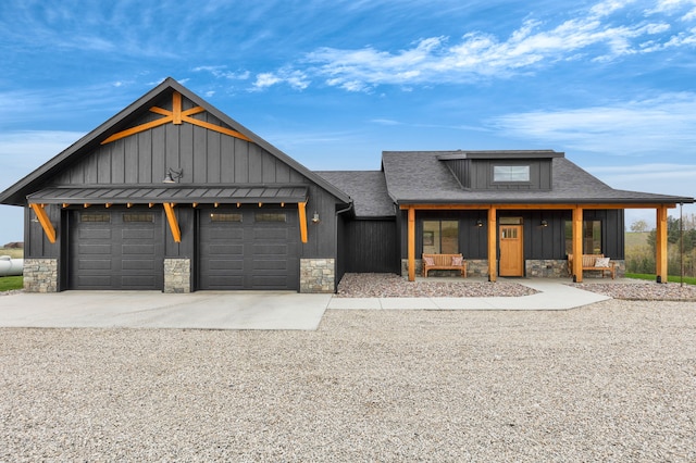 559 Stage Springs Ln, Stevensville, MT 59870 - view of front of property featuring stone siding, board and batten siding, concrete driveway, and an attached garage