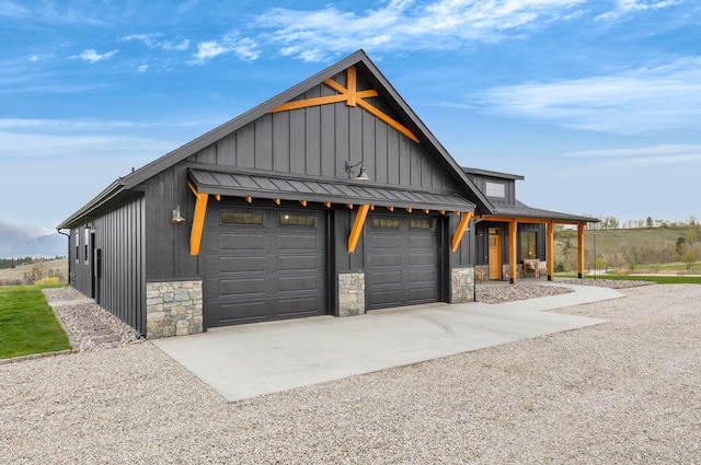 559 Stage Springs Ln, Stevensville, MT 59870 - garage with concrete driveway and covered porch