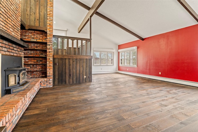 unfurnished living room featuring beam ceiling, wood-type flooring, a wood stove, high vaulted ceiling, and baseboards