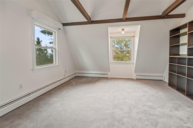 empty room featuring baseboard heating, healthy amount of natural light, and carpet floors