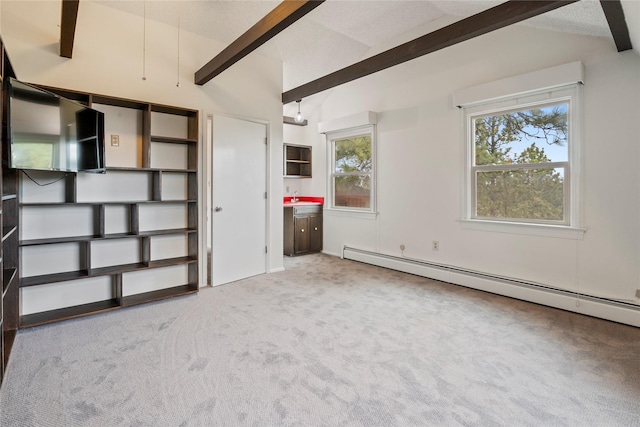 empty room featuring carpet flooring, a baseboard heating unit, and a sink