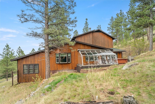 view of side of property featuring fence