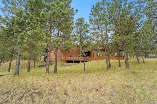 view of grassy yard featuring a deck