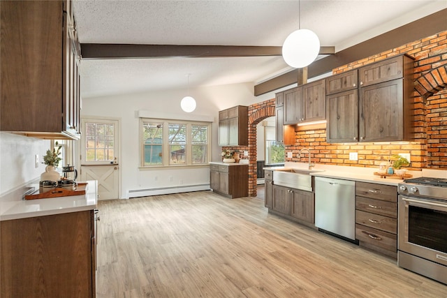 kitchen featuring stainless steel appliances, a sink, a baseboard radiator, light wood finished floors, and light countertops