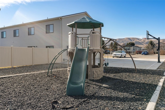 communal playground with fence and a mountain view