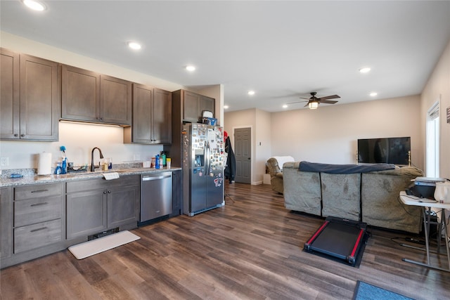 kitchen with appliances with stainless steel finishes, a ceiling fan, dark wood-style flooring, dark brown cabinets, and recessed lighting
