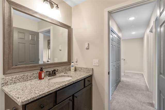 bathroom featuring baseboards and vanity