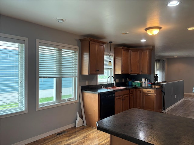 307 S Iowa St, Conrad, MT 59425 - kitchen featuring a sink, dark countertops, light wood-style flooring, dishwasher, and baseboards