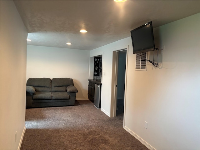307 S Iowa St, Conrad, MT 59425 - living room featuring dark colored carpet, baseboards, and recessed lighting