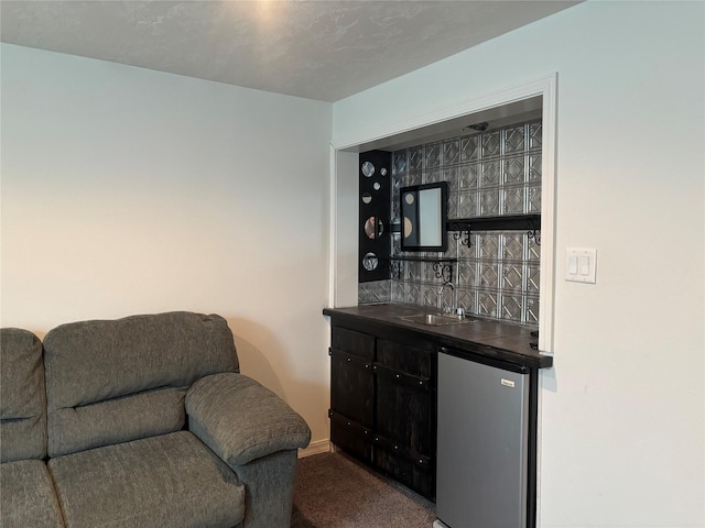 307 S Iowa St, Conrad, MT 59425 - indoor wet bar with freestanding refrigerator, dark carpet, and baseboards