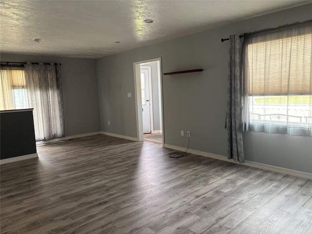 307 S Iowa St, Conrad, MT 59425 - spare room with plenty of natural light, wood finished floors, and baseboards
