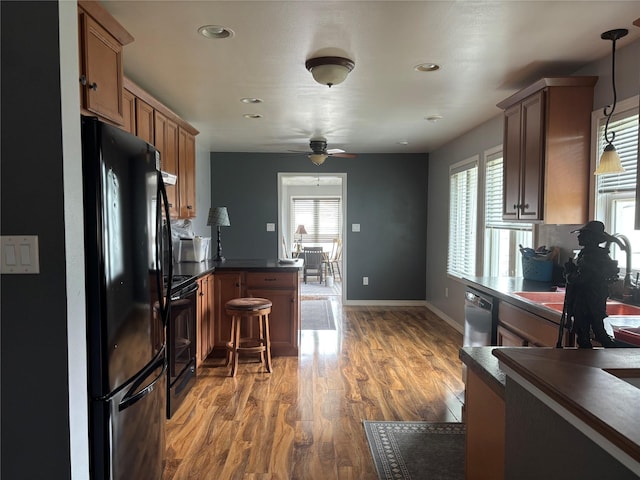 307 S Iowa St, Conrad, MT 59425 - kitchen featuring black appliances, dark countertops, a peninsula, ceiling fan, and recessed lighting
