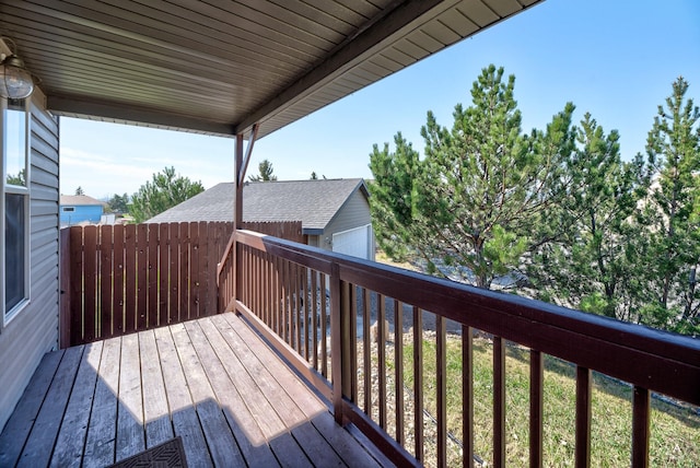 wooden terrace with a detached garage