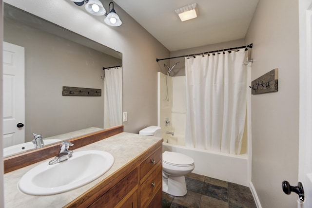 full bath with shower / bath combo, baseboards, vanity, stone finish floors, and toilet