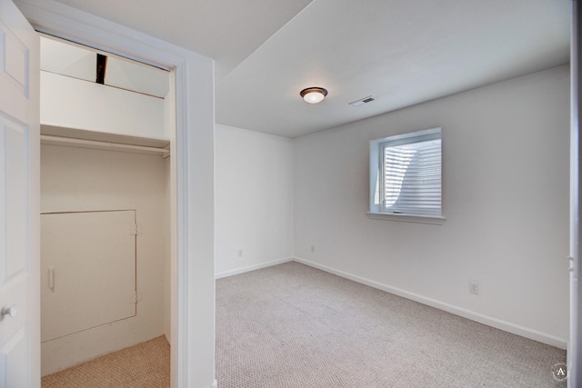 unfurnished bedroom with carpet flooring, baseboards, and a closet