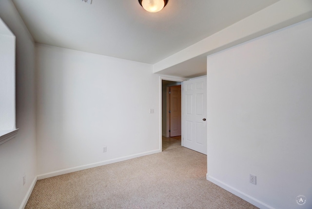 empty room featuring carpet flooring and baseboards