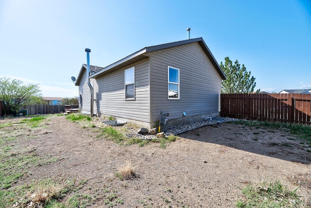 rear view of property with fence