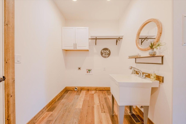 laundry area featuring hookup for a washing machine, cabinet space, light wood-type flooring, hookup for an electric dryer, and baseboards