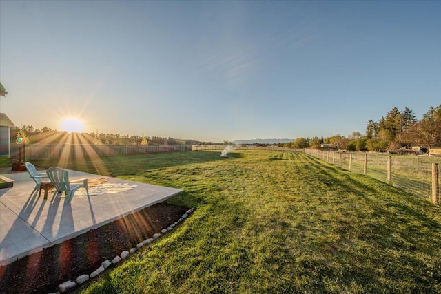 view of yard with a patio area and a view of countryside