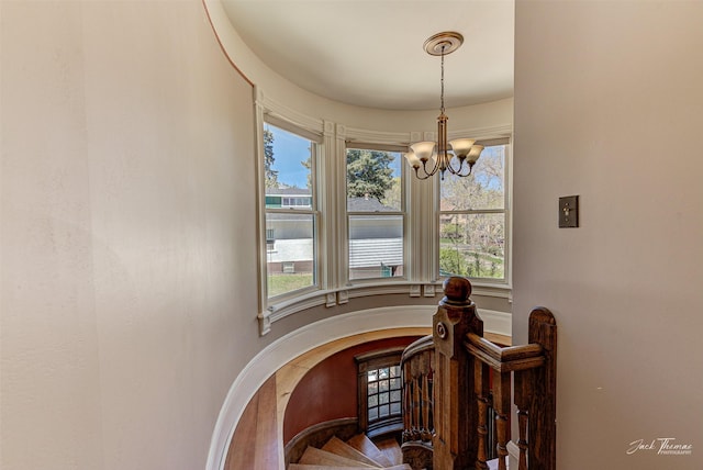 stairway featuring a chandelier and healthy amount of natural light