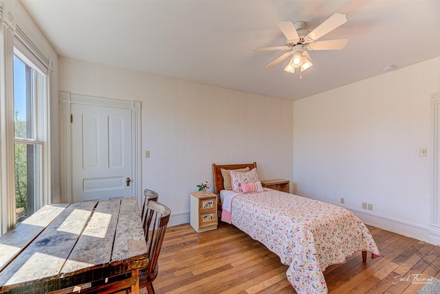bedroom with light wood finished floors and a ceiling fan