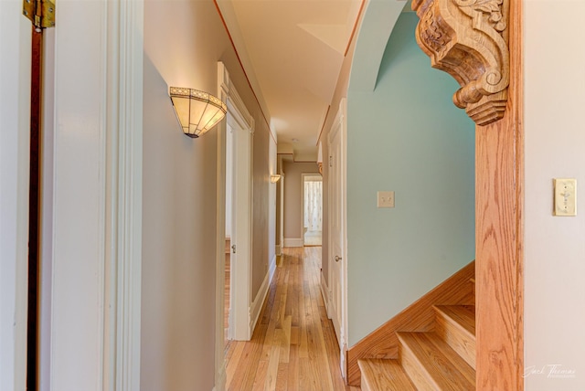 hallway featuring light wood-type flooring and baseboards
