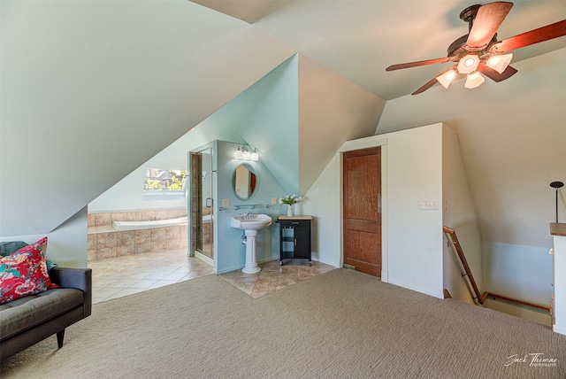 bonus room with a ceiling fan, lofted ceiling, and tile patterned floors