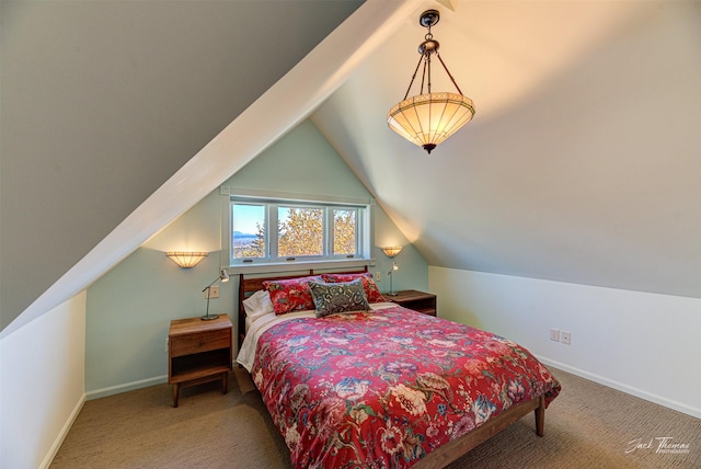 carpeted bedroom with vaulted ceiling and baseboards