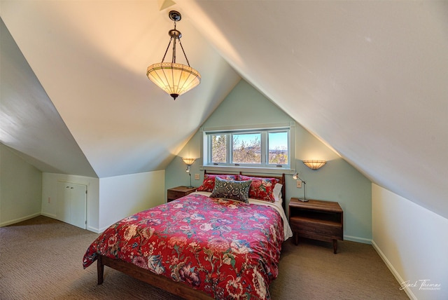 carpeted bedroom with lofted ceiling and baseboards