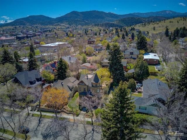 aerial view of property's location with mountains and nearby suburban area