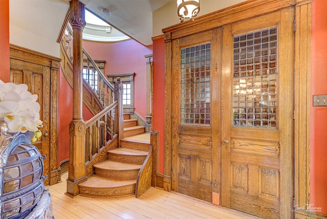 entryway with stairs and hardwood / wood-style flooring