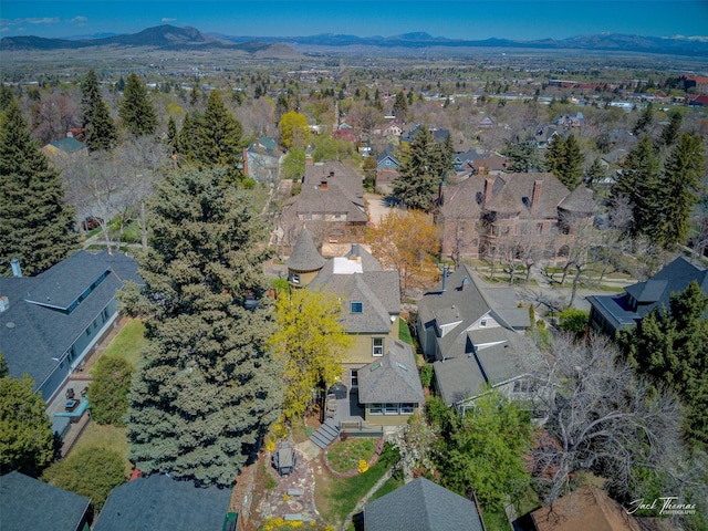 aerial overview of property's location featuring nearby suburban area and a mountain backdrop