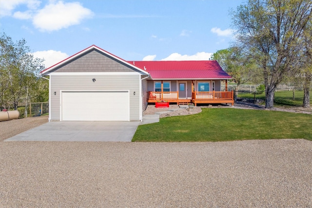 999 Websters Way, Stevensville, MT 59870 - view of front facade with a garage, concrete driveway, covered porch, and metal roof