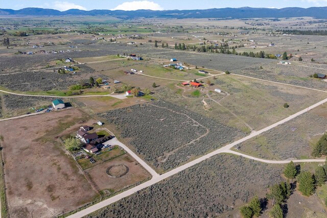 999 Websters Way, Stevensville, MT 59870 - aerial view of property and surrounding area featuring rural landscape and a mountainous background