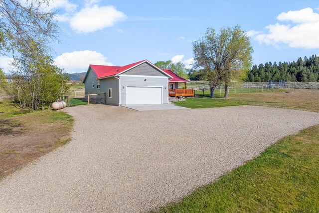 999 Websters Way, Stevensville, MT 59870 - view of home's exterior featuring driveway, an attached garage, and a deck