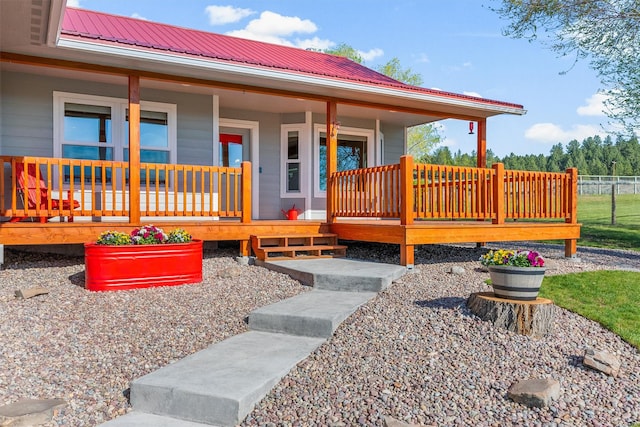 999 Websters Way, Stevensville, MT 59870 - view of exterior entry featuring metal roof, a porch, and fence