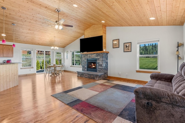 999 Websters Way, Stevensville, MT 59870 - living area featuring light wood-style floors, a fireplace, a ceiling fan, a chandelier, and plenty of natural light