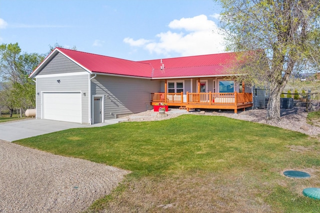 999 Websters Way, Stevensville, MT 59870 - ranch-style home featuring a garage, a front yard, metal roof, driveway, and a deck