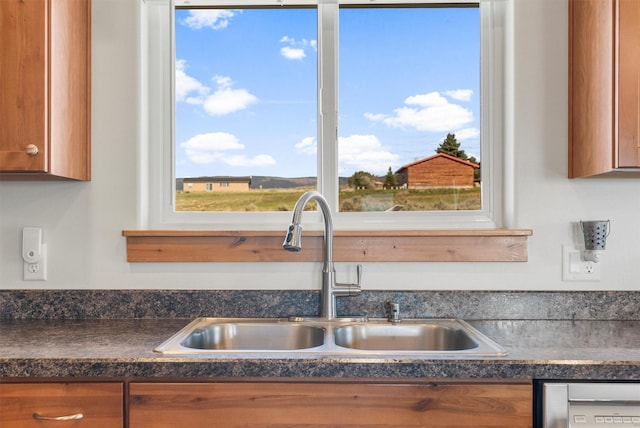 999 Websters Way, Stevensville, MT 59870 - kitchen featuring a sink, brown cabinets, dark countertops, and healthy amount of natural light