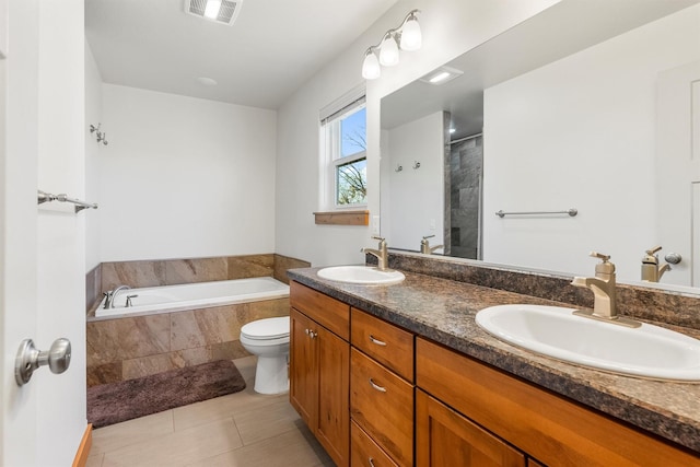 999 Websters Way, Stevensville, MT 59870 - bathroom featuring a garden tub, double vanity, toilet, a shower, and tile patterned flooring